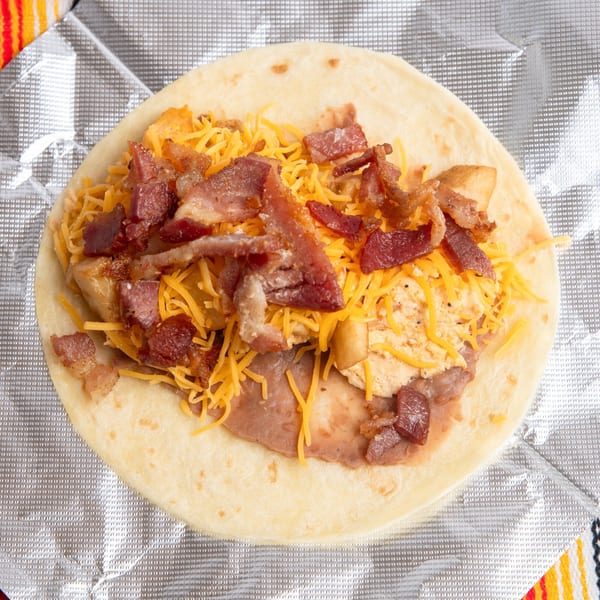 Pepe's Mexican Café breakfast burrito with bacon, scrambled eggs, cheese, and refried beans.
