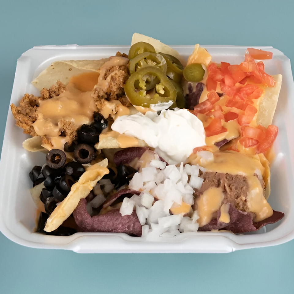 Pepe's Mexican Café nachos with cheese, ground beef, jalapeños, tomatoes, olives, onions, and sour cream.